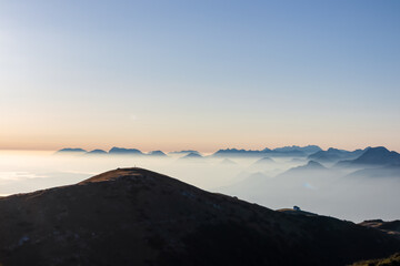 Panoramic sunrise view from Dobratsch on Julian Alps and Karawanks in Austria, Europe. Silhouette...