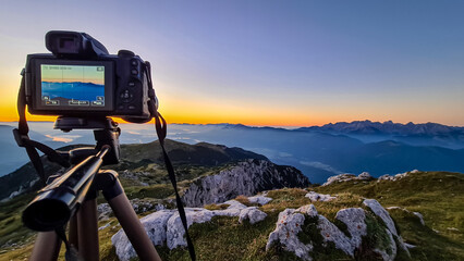Professional camera setup at sunrise on mountain peak of Dobratsch, Villacher Alps, Carinthia,...