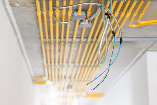 LAN network wire install in construction building with metal steel flexible conduit pipe with electricity wiring in PVC conduit pipe lines clean parallel installation.