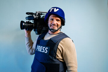Reporter in bulletproof vest holding a video camera