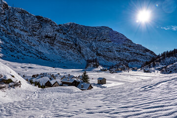 Snowy roofs in an alpine village - 694437673