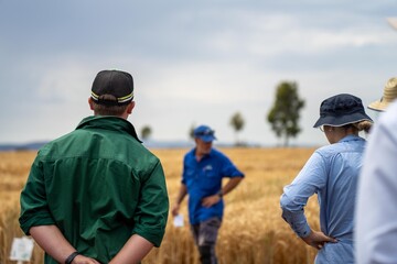 agricultural field day with a group of farmer growing wheat and barley cereal crops. learning about...