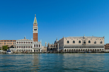 Fototapeta na wymiar Scenic view of the channel Canala Grande tower of St Mark's Campanile in city of Venice, Veneto, Northern Italy, Europe. Venetian architectural landmarks. Romantic vacation. Speed boat passing by