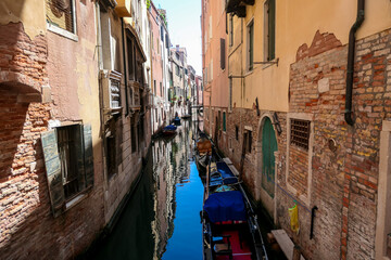 Floating boats with panoramic view of a water channel in city of Venice, Veneto, Italy, Europe....
