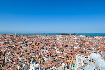 Fototapeta na wymiar Aerial view from St Mark bell tower Campanile of the old town of Venice, Veneto, Italy, Europe. Looking at Piazza San Marco and Doge's palace. UNESCO World Heritage Site. Urban tourism in summer