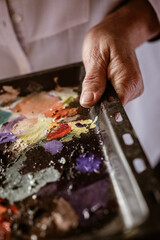 Painter mixing colourful oil painting
