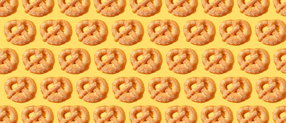 Many pretzels on yellow background. Pattern for design