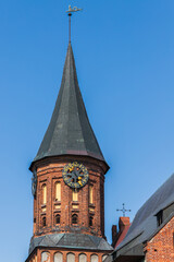 Fototapeta na wymiar Spire and tower clock of the Konigsberg Cathedral on a summer day