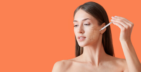 Portrait of beautiful woman applying cosmetic serum on orange background with space for text