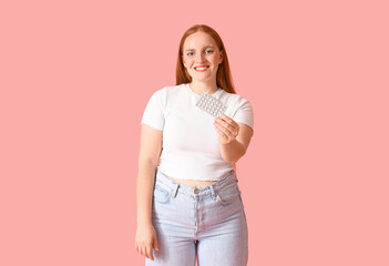 Young woman with contraceptive pills on pink background