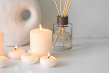 Fototapeta na wymiar Burning candles on white background