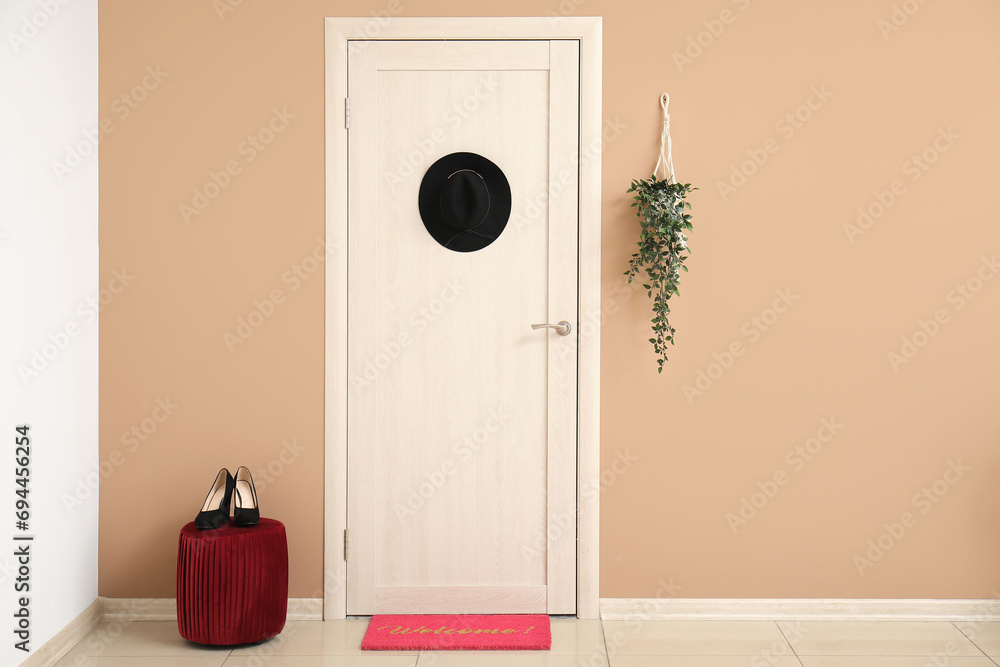 Poster Interior of hall with door, mat and pouf