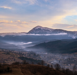 Obraz premium Picturesque morning above late autumn mountain countryside. Ukraine, Carpathian Mountains, Petros top in far. Peaceful traveling, seasonal, nature and countryside beauty concept scene.
