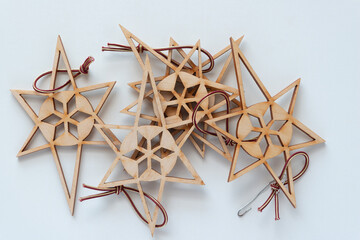 laser-cut wood stars with decorative detailing and ties on blank paper