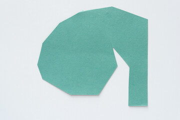 green paper shape with angular edges on white
