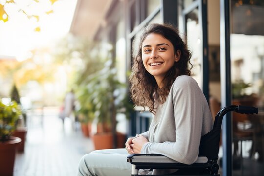 Young Woman In Wheelchair Working In A Modern Office With Plants