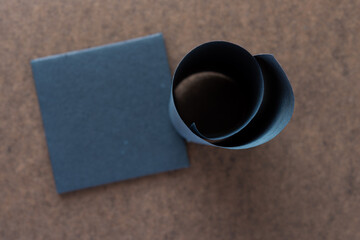 paper curl and tile on dark wood