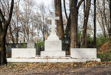 Fototapeta na wymiar Cross at cemetery. Religious gravestone. Death concept