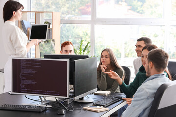 Team of young programmers working in office