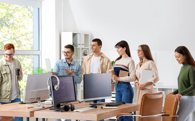 Team of young programmers working in office