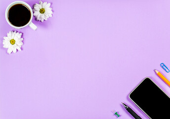 Stationery items, cup of coffee and phone on a purple background, office