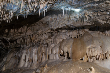 Amazing view of stalactites and stalagmites in colourful bright light, beautiful natural landmark in touristic place.