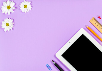 Stationery items tablet on a purple background, office