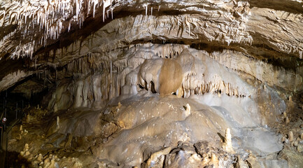 Amazing view of stalactites and stalagmites in colourful bright light, beautiful natural landmark...