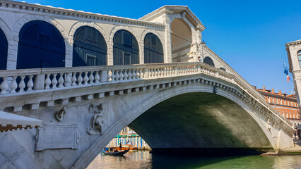 Channel Canal Grande with scenic view of famous Rialto bridge in city of Venice, Veneto, Northern Italy, Europe. Venetian architectural landmarks. Romantic vacation. Summer urban tourism