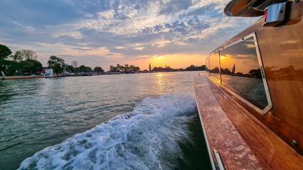 Boat ferry ride with scenic sunset view over Venetian lagoon seen from in Venice