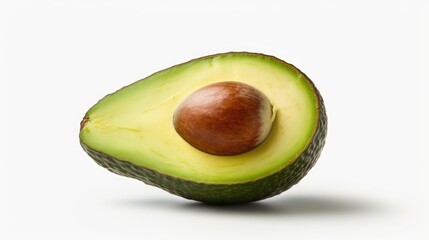 Avocado cut in half resting on a white surface. Suitable for food and healthy eating concepts