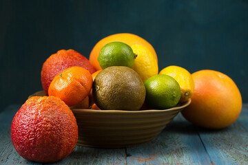 A variety of colorful citrus fruits, rustic still life