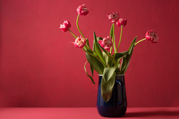 Beautiful bouquet of pink tulips in a blue vintage metal carafe