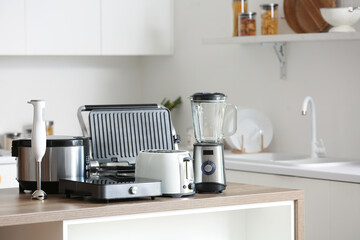 Set of modern appliances on wooden table in contemporary kitchen