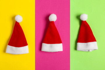 Santa Claus hats on colorful background