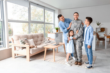 Fototapeta na wymiar Female soldier with her husband and little children at home