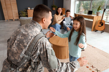 Little girl with her military father at home