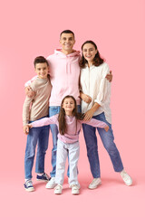 Little children with their parents hugging on pink background