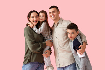 Fototapeta premium Little children with their parents hugging on pink background