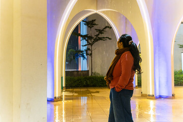 girl watching wall lightnings indoor shot at evening