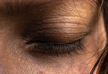 Close up of a closed eye and eyelids of a girl