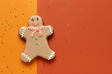 Christmas sweet gingerbread cookie and confetti on colorful background