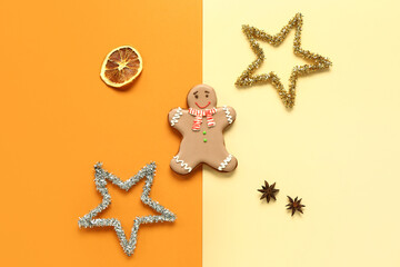 Fototapeta na wymiar Christmas sweet gingerbread cookie with star anise and dried orange on colorful background