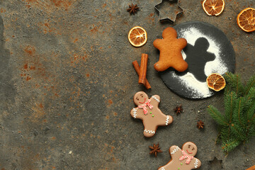 Christmas sweet gingerbread cookies with fir branches on dark background