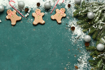 Christmas sweet gingerbread cookies with candy canes and fir branches on green background