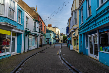 Fototapeta premium A view down Saint Georges Street away from the town walls in Tenby, Wales on a sunny day