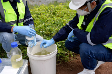 Environmental Engineers Team Take Water Samples at Natural Water Sources. Water that smells bad Near Farmland, Fish Ponds May Be Contaminated by Toxic Suspicious Pollution Sites.