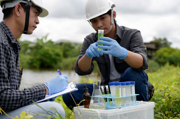 Environmental Engineers Inspect Water Quality, pH Test and Take Water sample notes in The Field...
