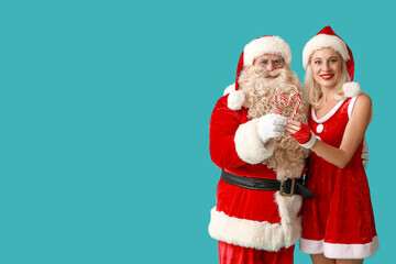 Santa and MRS Claus with candy canes on blue background