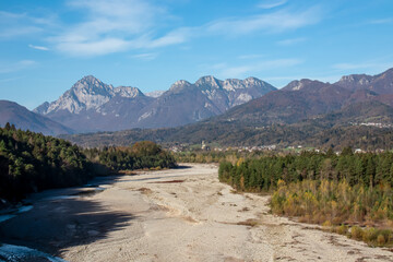 Scenic view of braided river Tagliamento running through mountainous landscape with in...